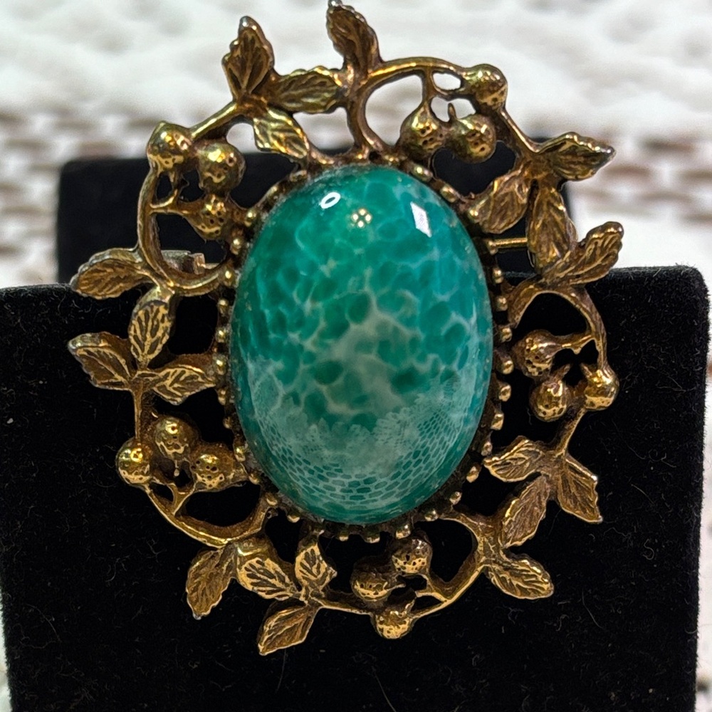 Goldette brooch with fabulous green mottled glass center